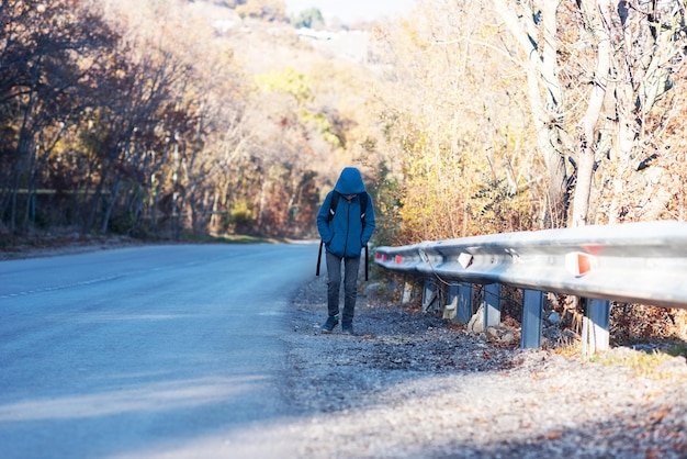 A small child walks alone along the road and cries ran away from home Family