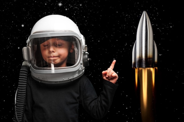 Small child wants to fly an in space wearing an astronaut helmet