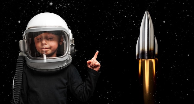 Small child wants to fly an in space wearing an astronaut helmet