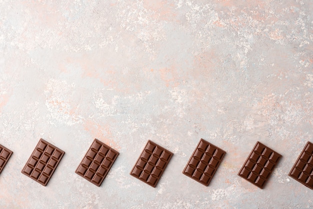 Small chocolate bars on a light background 