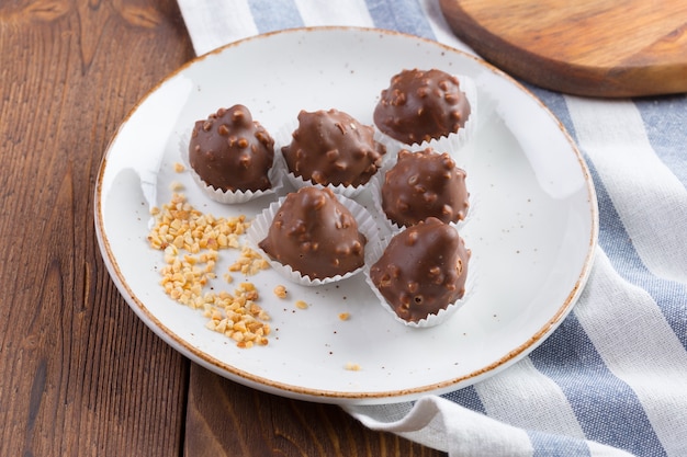 Small chocolate sweets with nuts close up