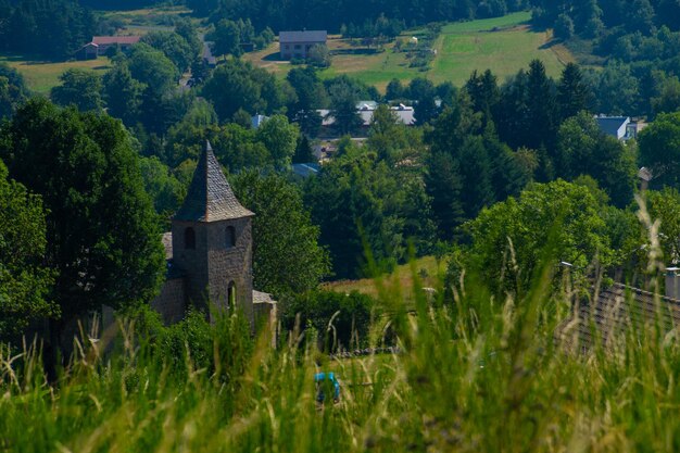 A small church in a field with trees and a field in the background