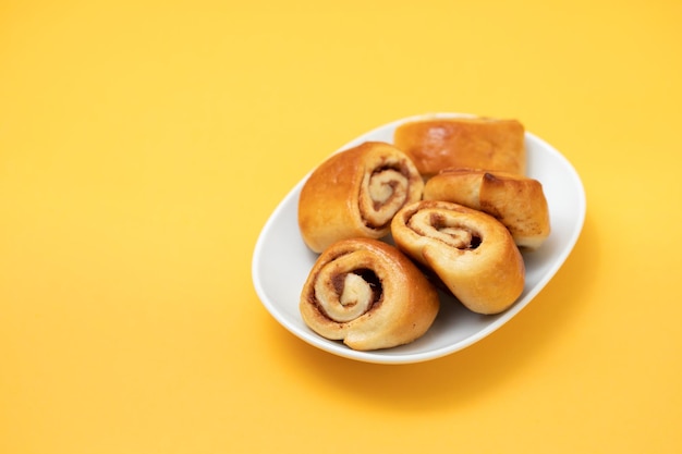 Small cinnamon buns on a white dish