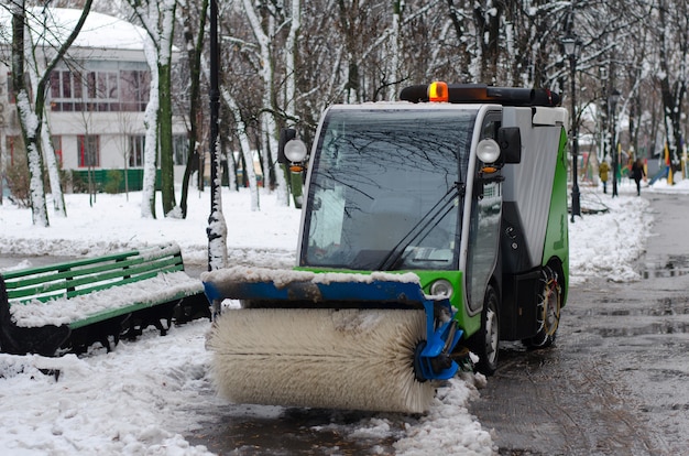 A small cleaning vehicle in the park.