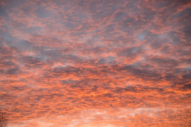 Small clouds are highlighted in red at sunset