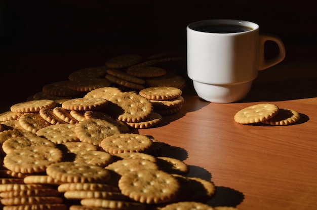 Small coffee cup and salted cracker