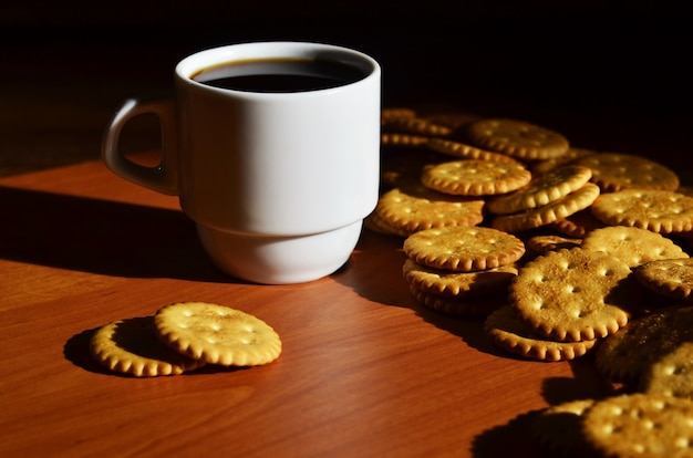 Small coffee cup and salted cracker