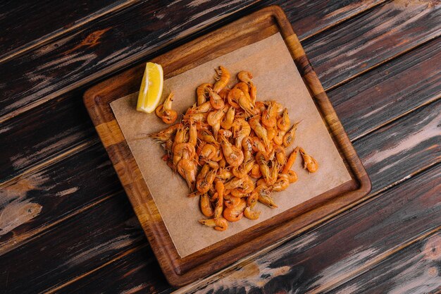 Small cooked shrimp on wooden tray