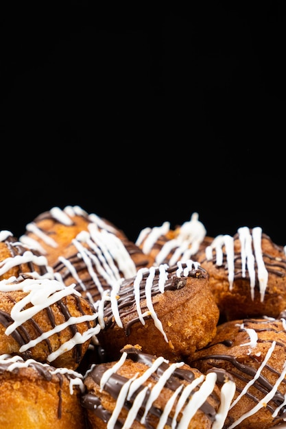 Small cupcakes with cocoa and white and milk chocolate with cream