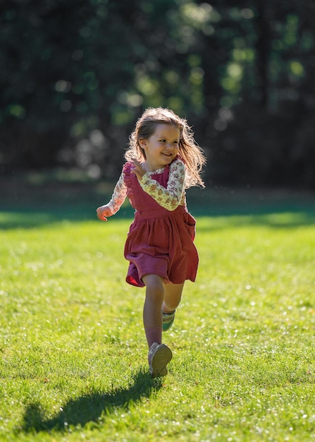 A small cute girl runs quickly Walk in the park Active lifestyle movement