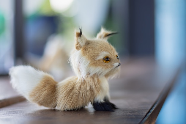 A small dog doll on a wooden table