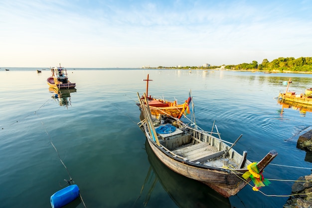 Small Fishing boat at shore on sunset