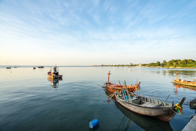 Small Fishing boat at shore on sunset