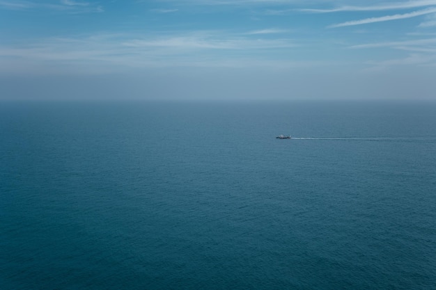 Small fishing boat in silent sea in the morning copy space in peaceful scenery and clear blue tones