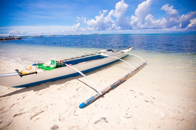 Small Fishing boat on the white tropical beach