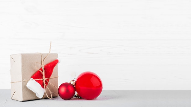 Small gift box with baubles on table