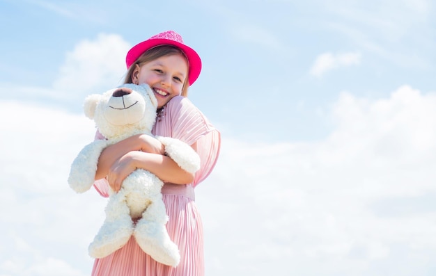 Small girl play with bear toy teddy bear shop toy shop for kids happy childrens day childhood happiness little cheerful child with present fluffy and cute gift happy birthday