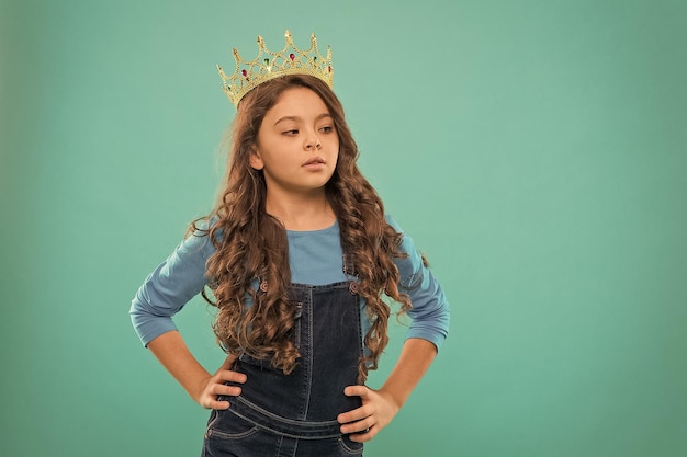 Small girl in queen crown feel herself like big boss being an egoist reward for real champion little princess selfish kid long curly hair luxury and success find your motivation copy space