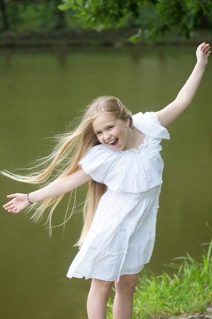 Small girl in white dress outdoor