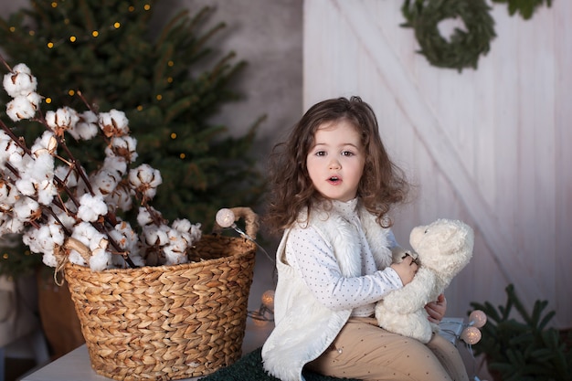 Small girl with Teddy bear on Christmas