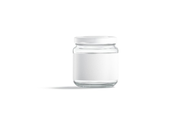 Small glass jar with white label. Closed preservation kitchenware. Glassware can for conservation.