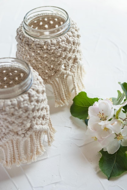 Small glass vase, jar, candleholder with macrame cover. Boho style. Bohemian home decor