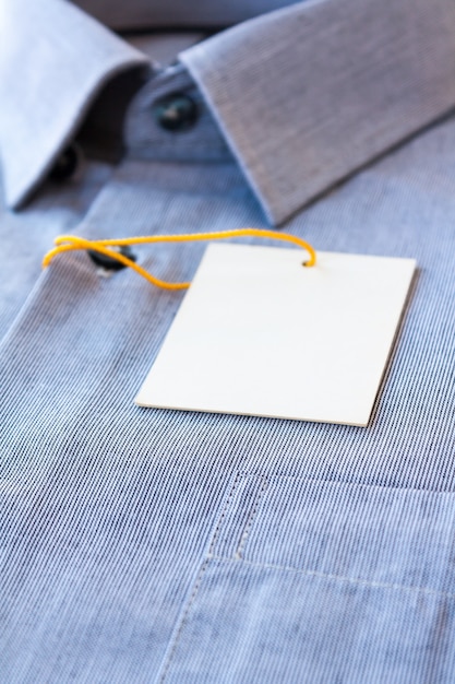 Small gray stripes men's shirt with a price tag and yellow-orange tag lanyard