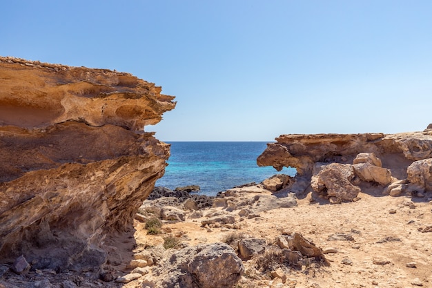 Small hidden rocky cove off the coast of the Ibiza island