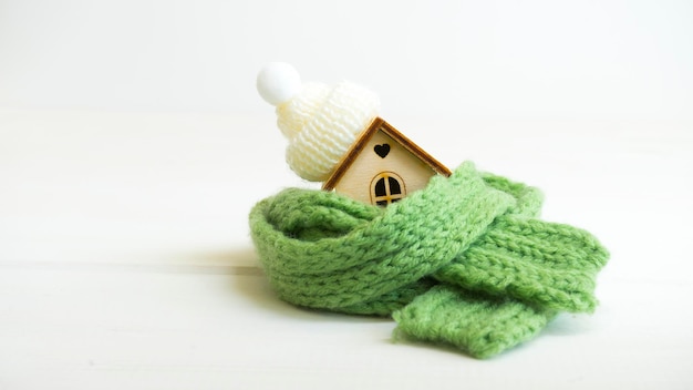 Small house wrapped in a scarf and hat