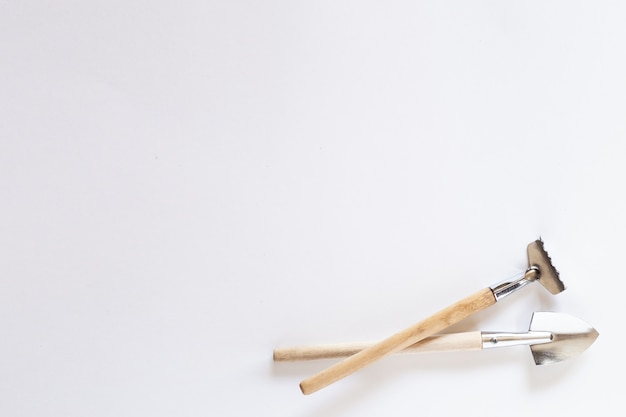 Small household shovel, rake, pitchfork on a white background