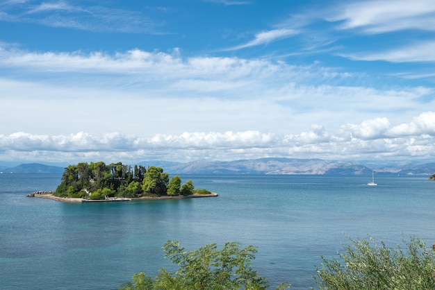 Small island with trees in Ionian sea.