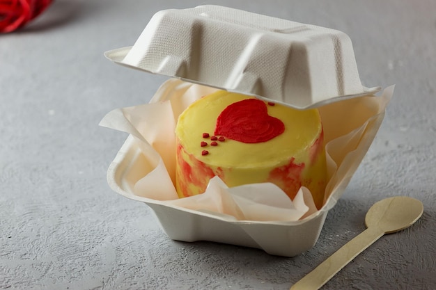 A small Korean-style bento cake in a box for one person. Cute dessert gift for birthday and valentine's day. Selective focus.