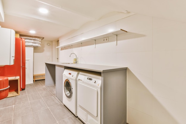 A small laundry room with appropriate appliances indoors in a modern residential apartment