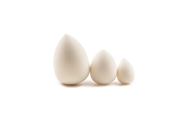 Small, medium and large  white beauty blender isolated on white.