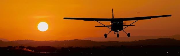 Small Plane Flying in the Air at Sunset