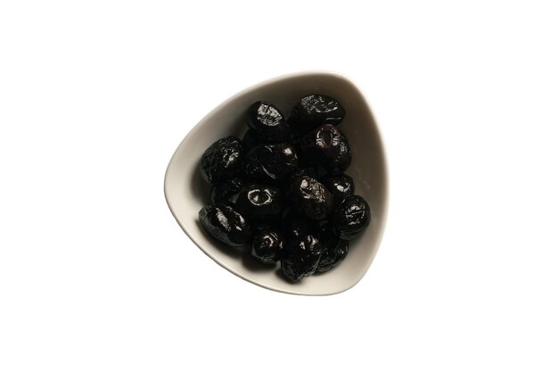 Small plate with black sundried olives in white plate on a white background Isolated