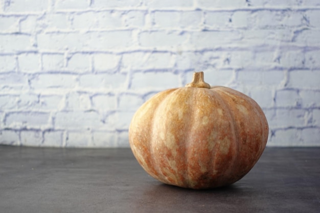 Small pumpkin on a table with copy space