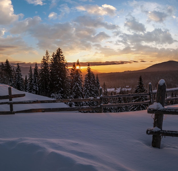 Small and quiet alpine village outskirts and winter sunrise snowy mountains around Voronenko Carpathian Ukraine