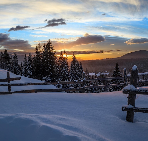 Small and quiet alpine village outskirts and winter sunrise snowy mountains around Voronenko Carpathian Ukraine