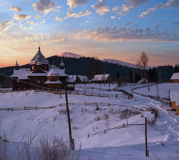 Small and quiet alpine village and winter sunrise snowy mountains around Voronenko Carpathian Ukraine