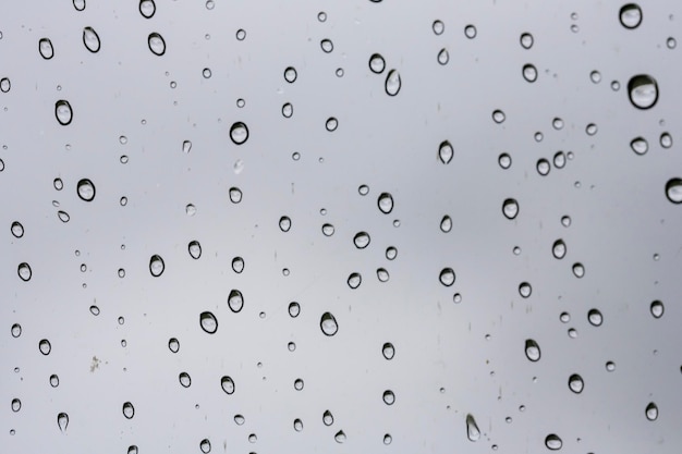 Small raindrop rests on the glass after rain