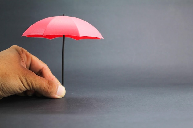 small red umbrella with a dark background insurance coverage concept