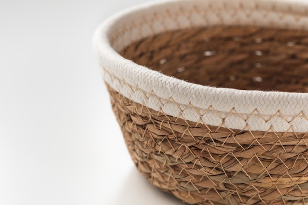 Small round seagrass and white cotton rope storage basket with rim