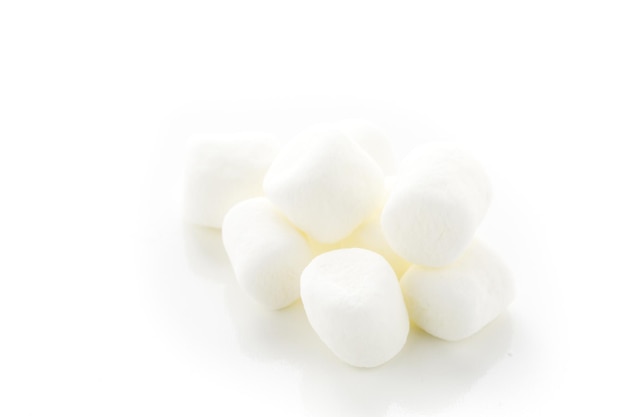 Small round white marshmallows on a white backgrouns.