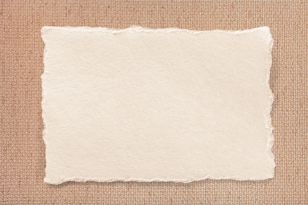 Small sheet of blank white rag paper from against brown bark paper