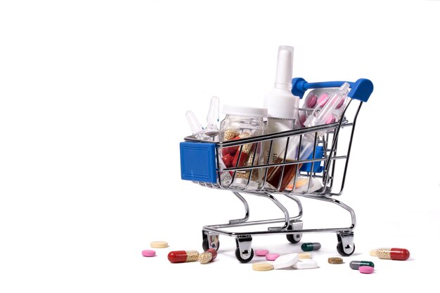 Small shopping cart with medicines on a white background