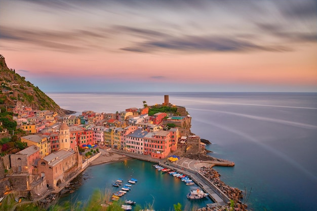 Small shoreside village with colorful buildings in Cinque Terre under an evening sky