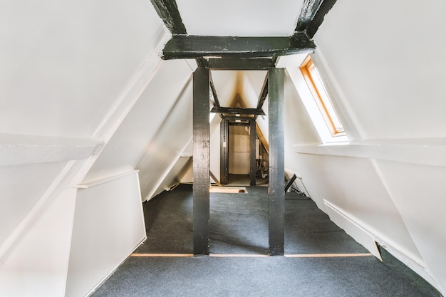 A small space in the attic of a residential building in the form of a triangle with black columns