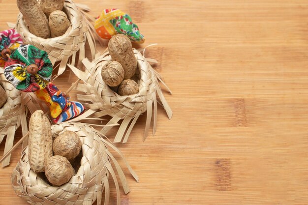 Small straw hats filled with peanuts with Brazilian festa junina decorations