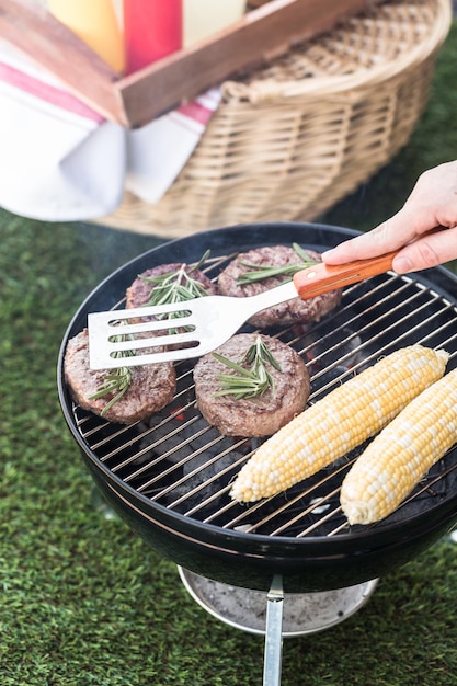 Small summer picnic with lemonade and hamburgers in the park.